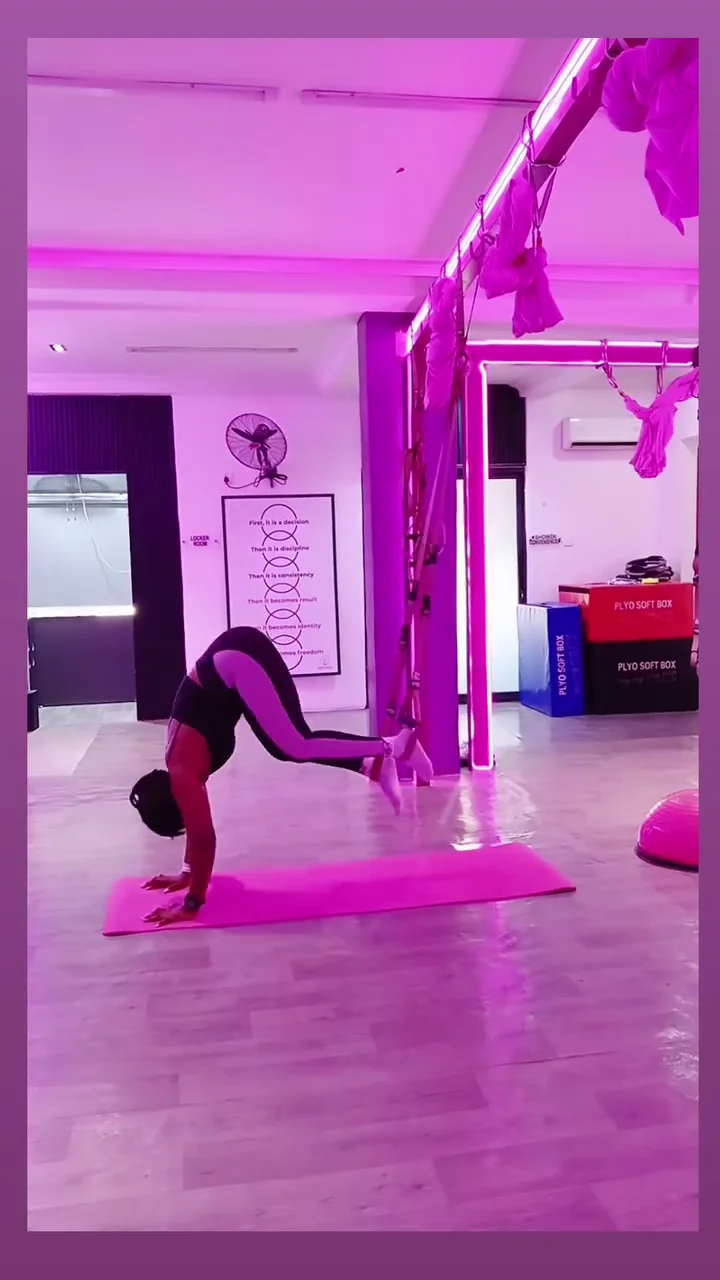 Woman training with battle ropes in the studio